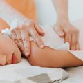 real doctor osteopath hands does physiological and emotional therapy for eight year old kid girl. pediatric osteopathy treatment session. alternative medicine. taking care of the child's health